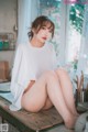 A woman sitting on top of a wooden table.