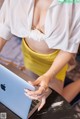 A woman sitting at a table with a laptop computer.