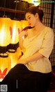 a woman sitting on a chair in front of a bunch of lanterns