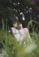 A couple of women standing next to each other in a field.