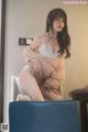 A woman sitting on top of a blue chair.